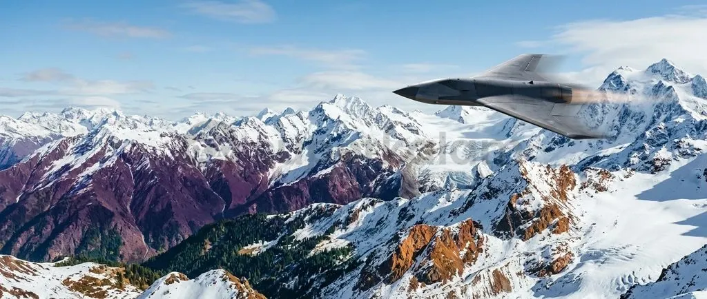 A modern jet-powered loitering munition cruising over high-altitude Himalayan mountain terrain